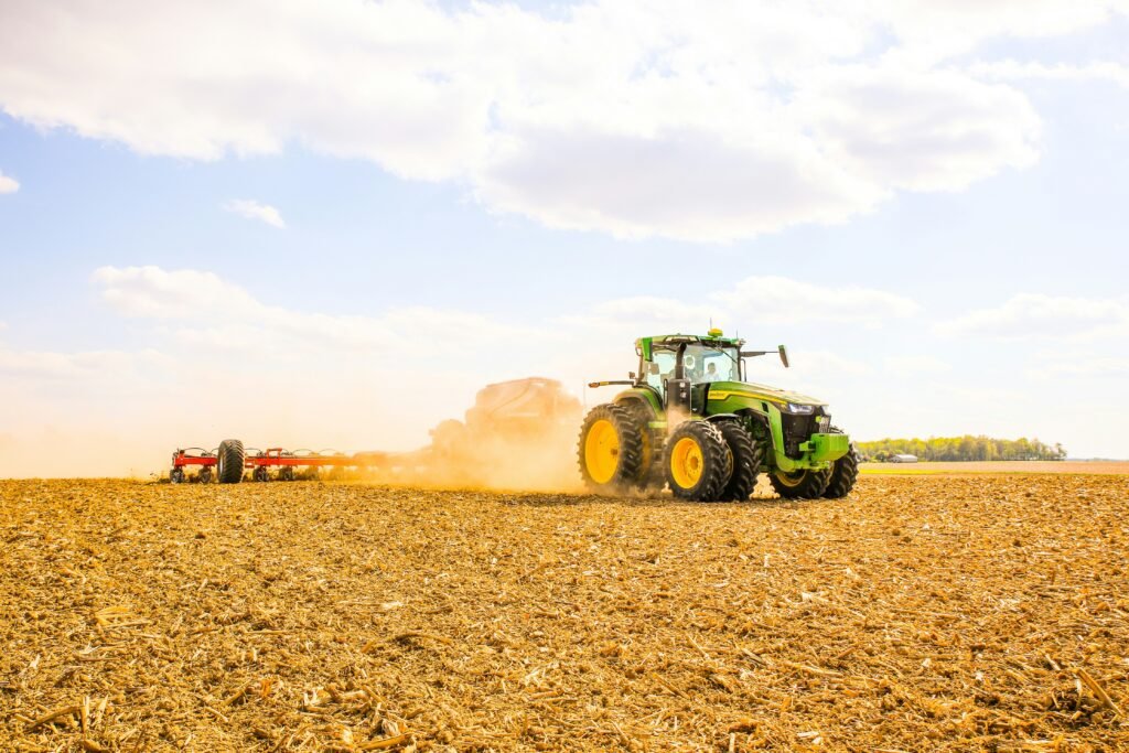 Tractor spreading bulk fertilizer on an agricultural field